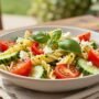 summer pasta salad in a shallow serving bowl